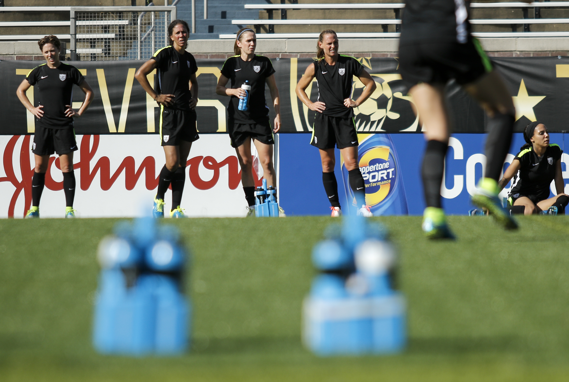Part of the U.S. Women's National Soccer Team rehydrate as they watch teammates practice at Finley Stadium on Tuesday, Aug. 18, 2015, in Chattanooga, Tenn. The team plays Costa Rica on Wednesday at Finley Stadium.