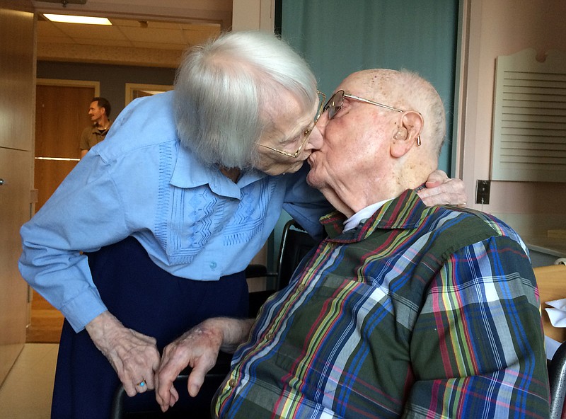 
              Walter and Leslie Kimmel, who are both 100 years old, enjoy a kiss as they celebrate their 75th wedding anniversary Tuesday, Aug. 18, 2015, at Charlestown Retirement Community in Catonsville, Md. The Kimmels met at Emmanuel Lutheran Church in Baltimore when they were 22 years old. Leslie played the organ and Walter sang in the choir.  (Paul J. Kessler/WBFF-TV via AP)
            