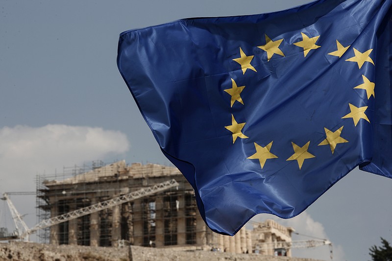 
              A European Union (EU) flag flutters in front of the temple of the Parthenon in Athens, Greece, Saturday, Aug. 15, 2015. Finance ministers of the 19-nation euro single currency group on Friday approved the first 26 billion euros ($29 billion) of a vast new bailout package to help rebuild Greece's shattered economy.  (AP Photo/Yorgos Karahalis)
            