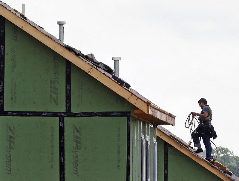 
              In this photo taken Tuesday, June 9, 2015, a roofer works on a home under construction in the Briar Chapel community in Chapel Hill, N.C. The Commerce Department releases housing starts for July on Tuesday, Aug. 18, 2015. (AP Photo/Gerry Broome)
            