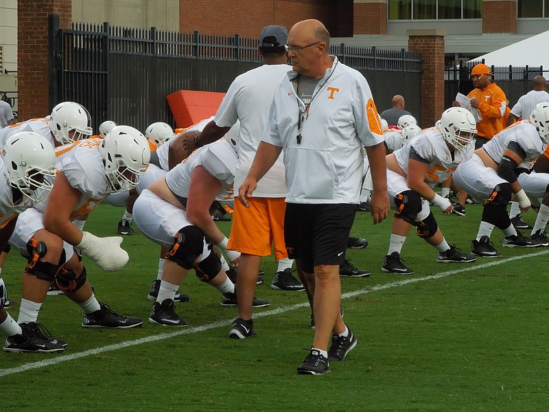 Tennessee offensive coordinator Mike DeBord watches as the Vols stretch before practice at Haslam Field on Aug. 6, 2015.