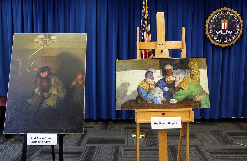 
              Michael's Knife, left, and The Unwrit Dogma paintings by N.C. Wyeth are displayed during an FBI news  conference in Los Angeles on Tuesday, Aug. 18, 2015 to announce in the investigation into the theft of valuable art stolen in 2013. The FBI is offering a reward of up to $20,000 for help in finding two N.C. Wyeth paintings stolen from a home in Portland, Maine. Four were recovered from a pawn shop in Beverly Hills, California, in December, and are estimated to be worth up to $2 million. But the remaining two were never found. (AP Photo/Nick Ut)
            