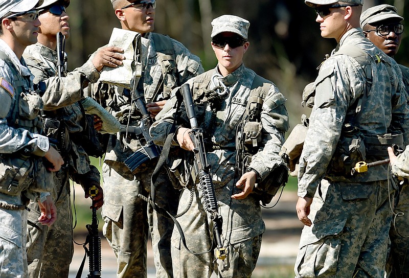 In this photo taken on Aug. 4, 2015, a female Army Ranger stands with her unit during Ranger School at Camp Rudder on Eglin Air Force Base, Fla.