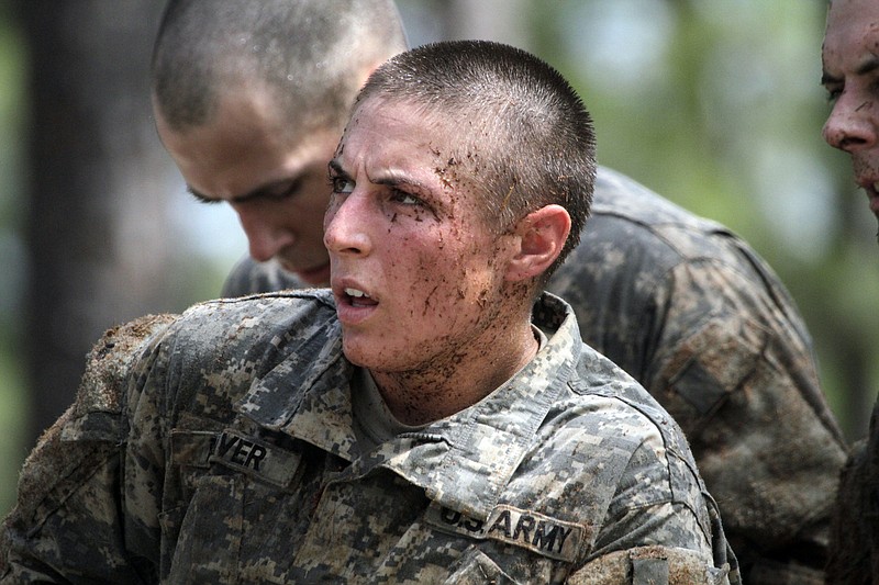 In this photo taken on April 26, 2015, one of the 20 female soldiers, who is among the 400 students who qualified to start Ranger School, tackles the Darby Queen obstacle course, one of the toughest obstacle courses in U.S. Army training, at Fort Benning, in Ga.