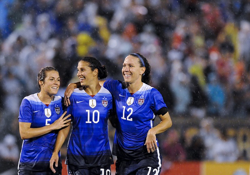 USA's Kelley O'Hara, Carli Lloyd, and Lauren Holiday, from left, react to a point scored during the U.S. Women's National Soccer Team's match against Costa Rica at Finley Stadium on Wednesday, Aug. 19, 2015, in Chattanooga, Tenn. The team is playing in Chattanooga as part of its Women's World Cup victory tour.