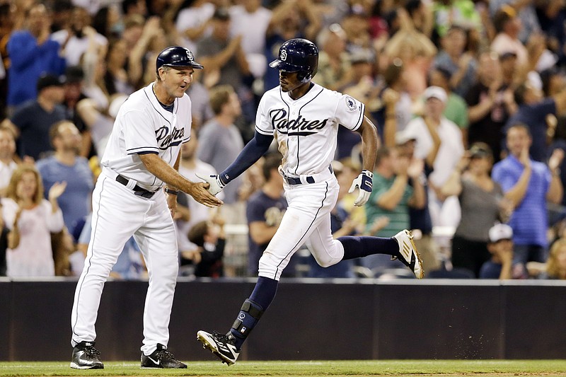 San Diego Padres' Melvin Upton Jr., right, is greeted by third base coach Glenn Hoffman after hitting a two-run home run against the Atlanta Braves during the sixth inning of a baseball game Tuesday, Aug. 18, 2015, in San Diego. 