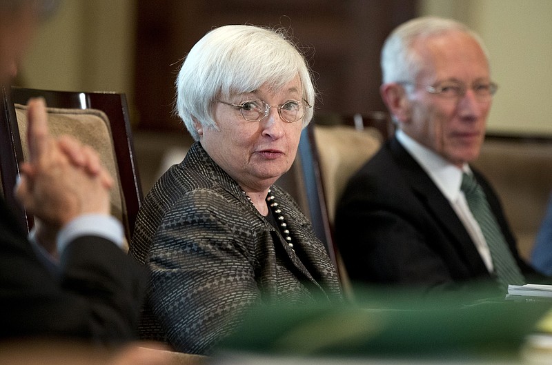 
              FILE - In this July 20, 2015, file photo, Federal Reserve Chair Janet Yellen, from left, with Vice Chairman Stanley Fischer, and the board of governors of the Federal Reserve System, presides over a meeting in Washington. The Federal Reserve releases minutes from its July interest-rate meeting on Wednesday, Aug. 19, 2015. (AP Photo/Manuel Balce Ceneta, File)
            