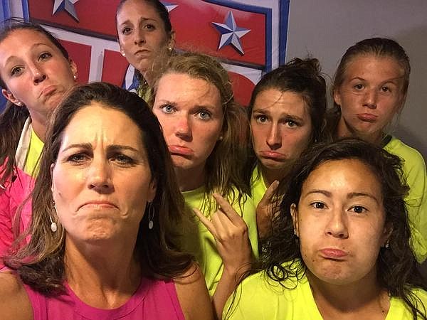 Julie Foudy, bottom left, with members of the UTC soccer team the rain delay during the United States women's national team match against Costa Rica.