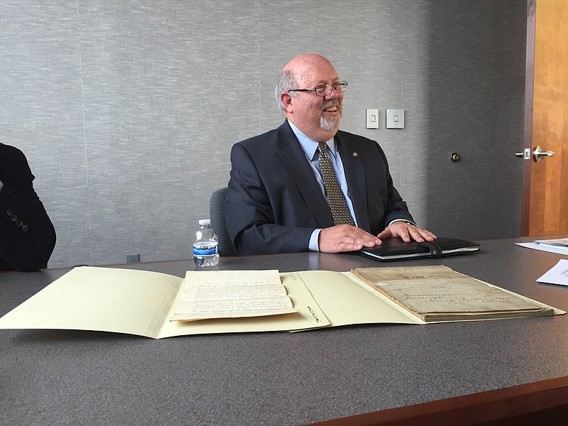 Charles A. Sherrill, State Librarian and Archivist for the Tennessee State Library and Archives shows historic bills.