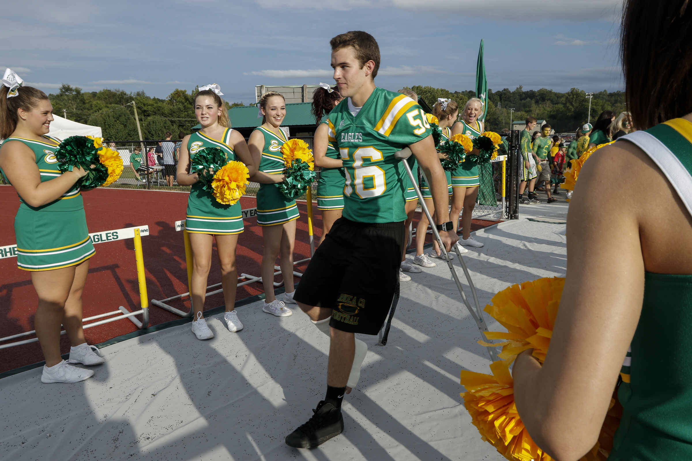Rhea County player Justin Rogers walks on crutches to enter the field before their prep football game against Baylor at Rhea County High School on Thursday, Aug. 20, 2015, in Evensville, Tenn.