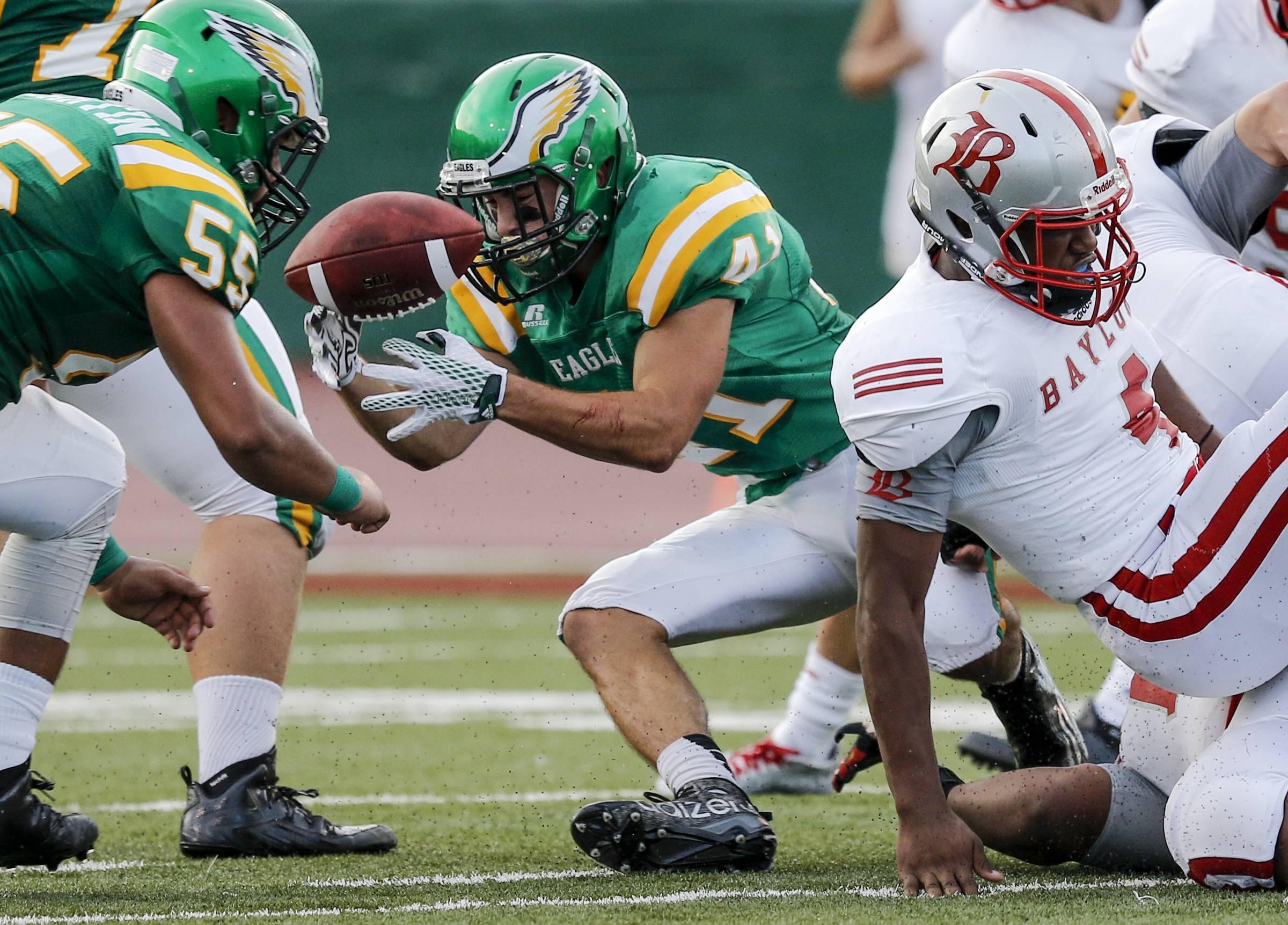 Rhea County's Dylan Smith (41) fumbles the ball during their prep football game against Baylor at Rhea County High School on Thursday, Aug. 20, 2015, in Evensville, Tenn. Rhea county recovered the fumble.