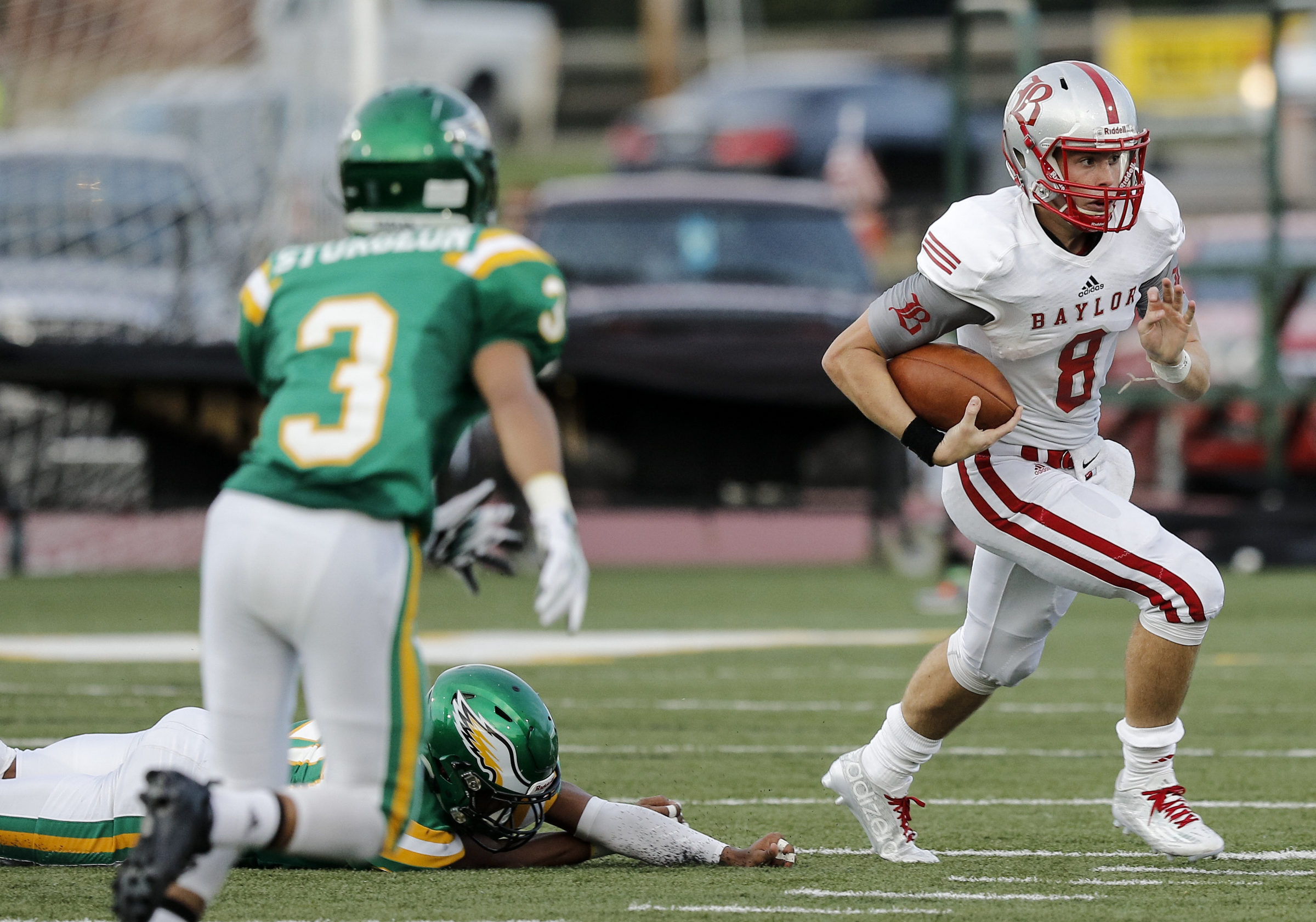 Baylor quarterback Wil Austin carries towards Rhea County's Chris Sturgeon during their prep football game at Rhea County High School on Thursday, Aug. 20, 2015, in Evensville, Tenn.