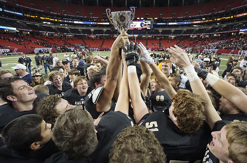 Staff Photo by Dan Henry / The Chattanooga Times Free Press- 12/12/14. Calhoun High School players celebrate their win over Washington County during the GHSA class AAA championship game at the Georgia Dome in Atlanta, Ga. on Friday, December 12, 2014.  The Yellowjackets won the state championship over the the Golden Hawks with a final score of 27-20. 