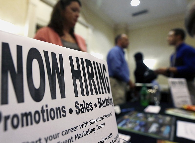 A sign attracts job-seekers during a job fair at the Marriott Hotel in Colonie, N.Y in this file photo.