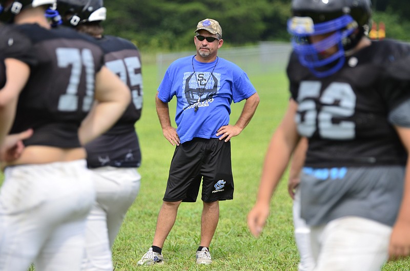 Head coach Ron Cox watches his players during football practice at a practice field at North Hamilton County Middle School in Sale Creek, TN on August 11, 2014.