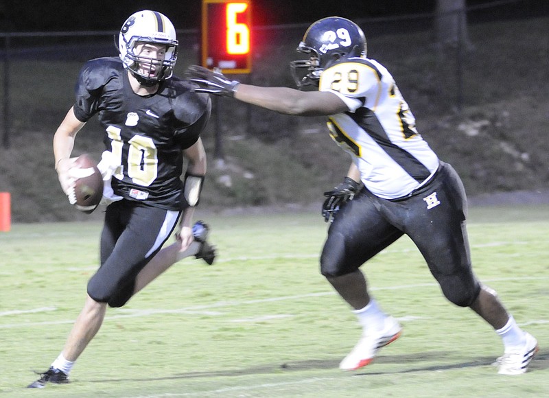Hixson's Elijah White, right, reaches for Bradley Central quarterback Cole Copeland in second quarter action in Cleveland. White was called for a face mask penalty on the play.
