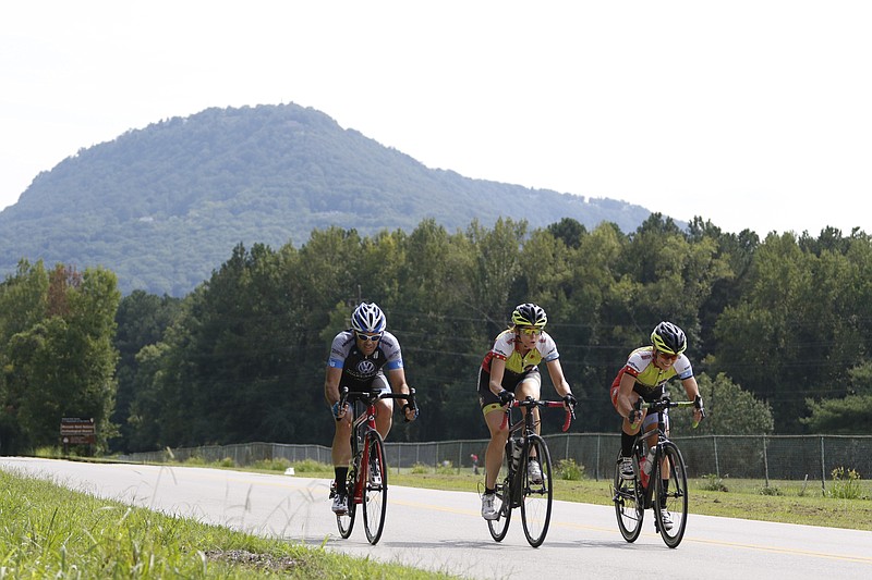 Steve Lewis, Cathi Swanson and Deborah Gibb, from left, perform "openers" near Moccasin Bend in preparation for this weekend's Village Volkswagen River Gorge Omnium bicycle race being held in downtown Chattanooga August 22-23, 2015. 