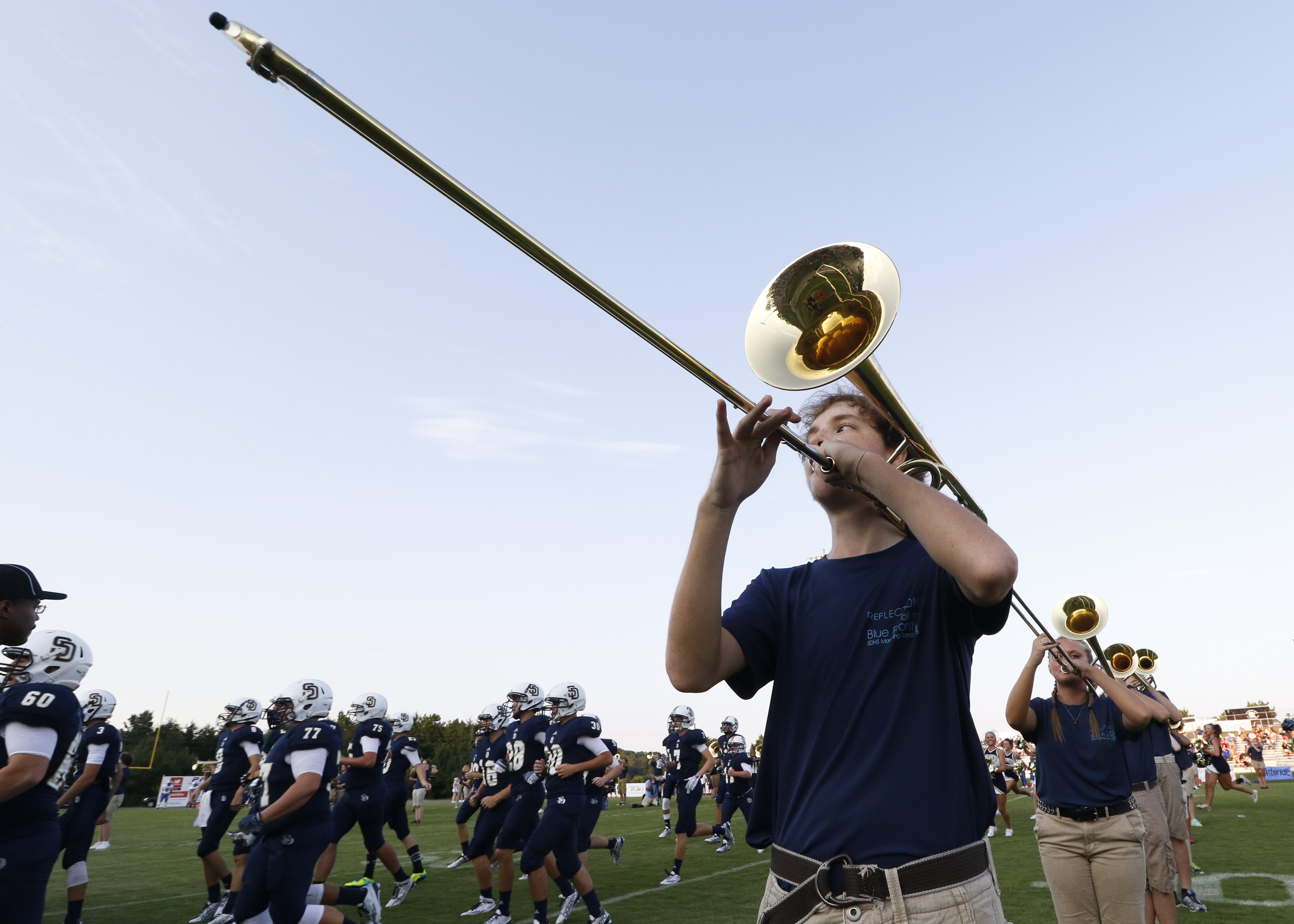 Soddy-Daisy senior classman Michael Triplett plays the trombone as the Trojans take the field to play Red Bank High School on Friday, August 21, 2015.