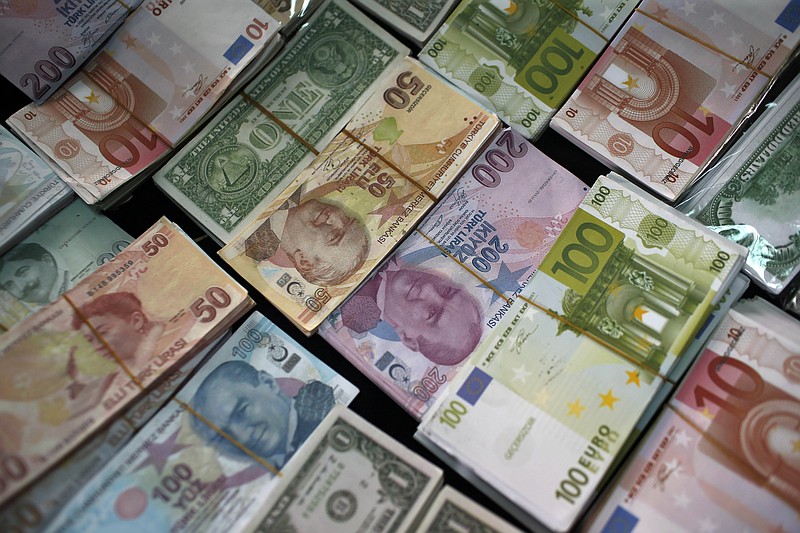 
              FILE - In this Monday, June 8, 2015 file photo, Turkish Liras, Euros and U.S. Dollars are stacked at a currency exchange office in Istanbul, Turkey. In emerging markets worldwide, currencies are plunging over fears that developing economies are on the verge of a crippling fall. The damage has spilled across oceans. The Dow Jones industrials plunged 328 points, nearly 2 percent, in early-afternoon trading Friday, Aug. 21, 2015 on top of a 358-point drop Thursday. (AP Photo/Emrah Gurel)
            