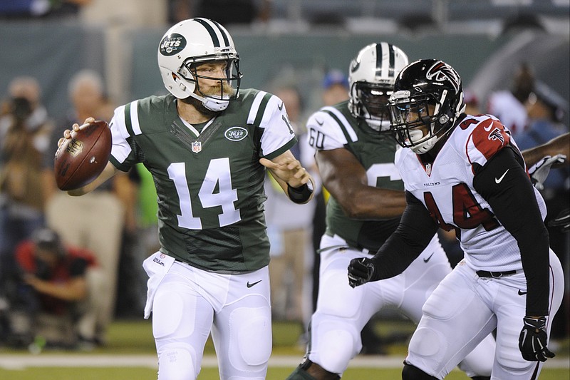 New York Jets quarterback Ryan Fitzpatrick (14) throws a pass as Atlanta Falcons' Vic Beasley (44) rushes him during the first half of a preseason NFL football game Friday, Aug. 21, 2015, in East Rutherford, N.J. 