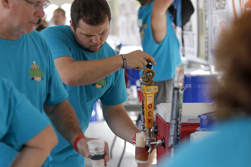 Nick Tomaszewski pours a Shiner beer at the Southern Brewers Festival at Ross's Landing on Saturday, Aug. 22, 2015, in Chattanooga.