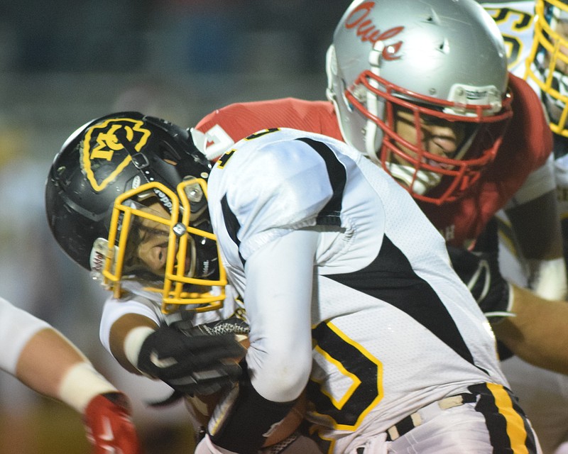 McMinn County's Xavier Abernathy (10) grimaces as he is tackled by Ooltewah's Ashton Watson (77).  The McMinn County Cherokees visited the Ooltewah High Owls in the final regular season game in their TSSAA season.  