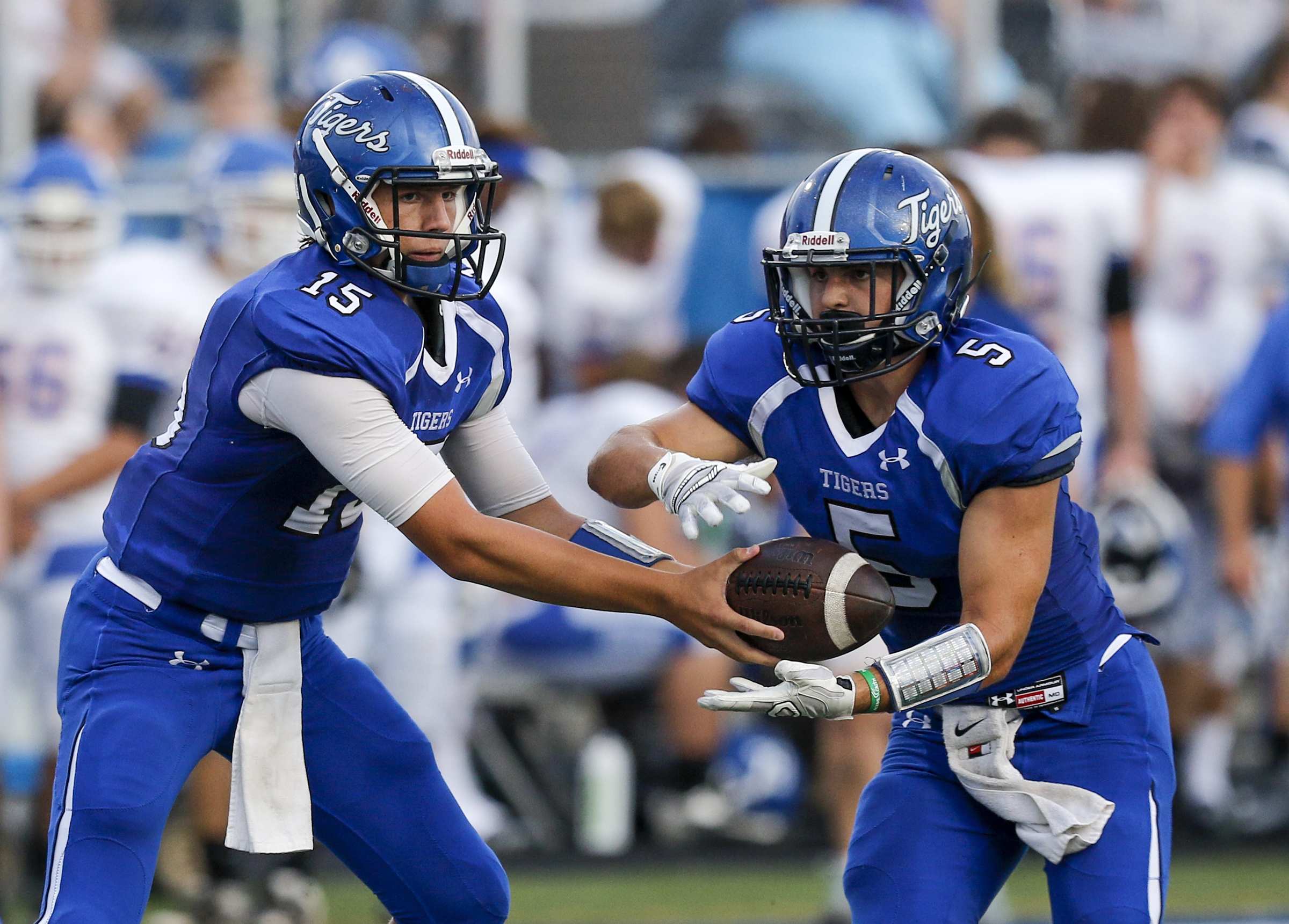 Ringgold quarterback Devin Lancaster, left, hands the ball to Hunter Foskey during their prep football game against Northwest Whitfield at Ringgold High School on Saturday, Aug. 22, 2015, in Ringgold, Ga.