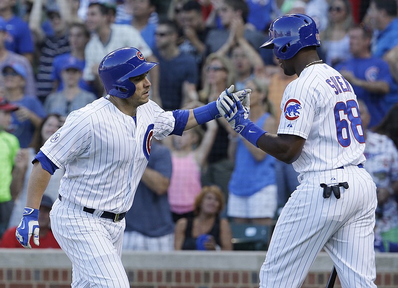 Chicago Cubs' Miguel Montero, left, celebrates with Jorge Soler after hitting a solo home run during the eighth inning of a baseball game against the Atlanta Braves on Saturday, Aug. 22, 2015, in Chicago.