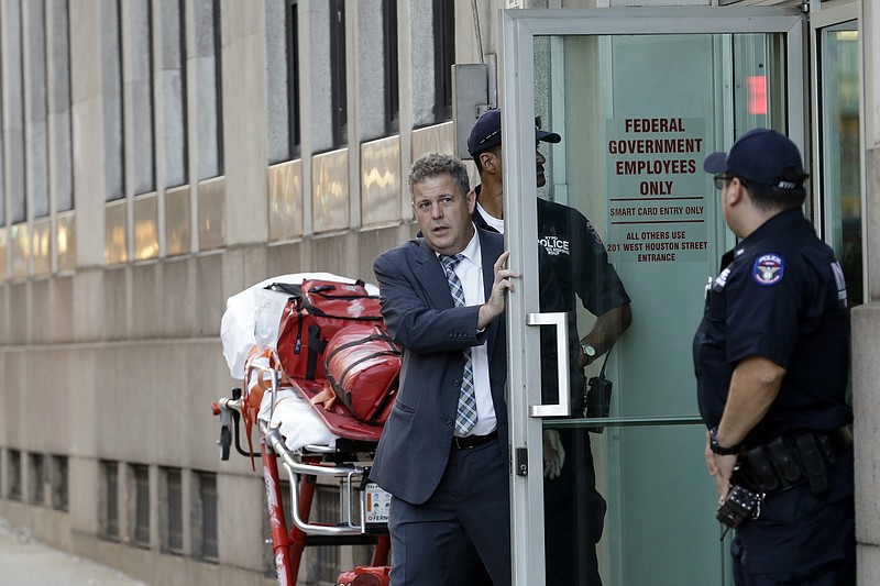 
              Officers work at the scene following a shooting at a federal building, Friday, Aug. 21, 2015, in New York. Police said a man walked into the building and opened fire before shooting himself. (AP Photo/Mary Altaffer)
            