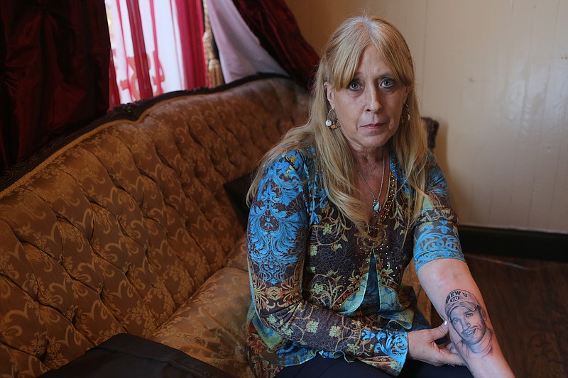 Rita Stonecipher sits in the lobby of Blackbeard Tattoo after getting a tattoo of her son, Tanner on June, 25 2015. Stonecipher has early-onset Alzheimer's Disease and is worried about forgetting her son who passed away three years ago. (Staff photo by Maura Friedman) 
