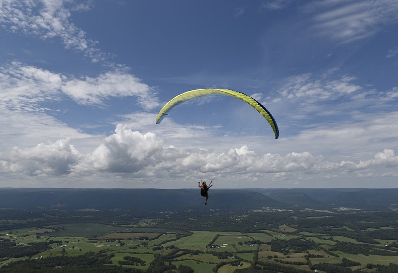 Lindsay Matush launches in a parasail from the bluff of Walden's Ridge into the Sequatchie Valley on Saturday, Aug. 22, 2015, in Dunlap, Tenn. People from around the country and around the world participated in the week-long Team Challenge at the Tennessee Tree Toppers launch site as well as in Whitwell. 