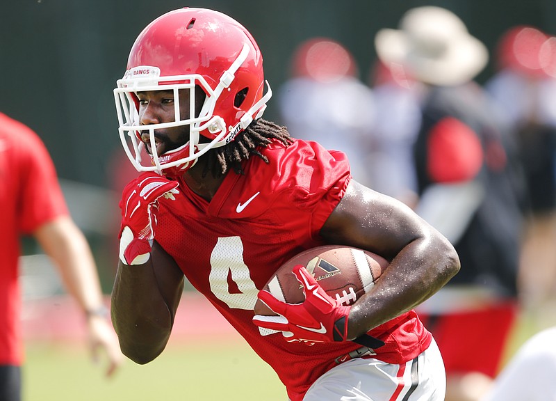 Georgia running back Keith Marshall (4) carries the ball during NCAA college football practice in Athens, Ga., in this file photo.
