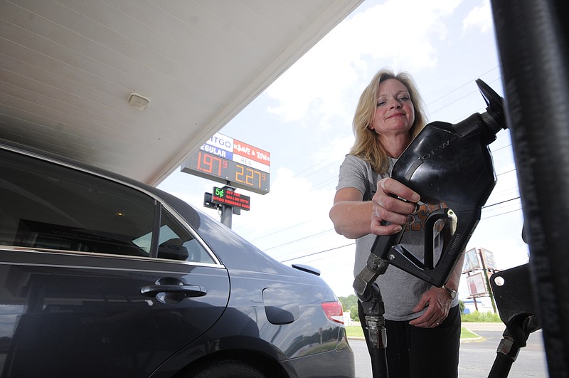 Memorial Pediatric Operating Room Nurse Georganne Hamilton reaches to fuel her car Monday at the Save-A-Ton Citgo fuel stop at 5701 Highway 153 on Monday. "I'm here just because of the gas price," Hamilton said. "I hope it stays this way."