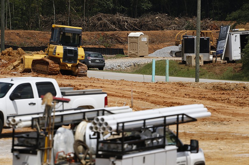 Work begins to fill a retaining pond across the street from the site of the new Bass Pro Shop that is being built in East Ridge, Tenn., on August 24, 2015.