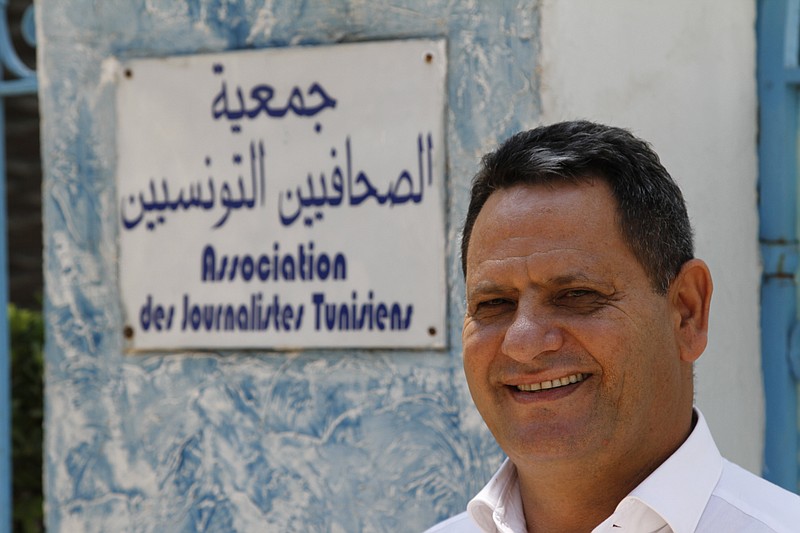 
              Neji Bghouri, the head of Tunisia's journalists' union poses for a portrait in front of his office after discussing the new threats to free expression in Tunis, Tunisia, Sunday Aug. 8, 2015. Seven men spent a week in prison on terrorism charges, suffering what they claim was torture under custody, before a judge released them for lack of evidence. But as they stepped out of the courthouse in early August, plainclothes policemen swooped in and spirited them away. (AP Photo/Paul Schemm)
            