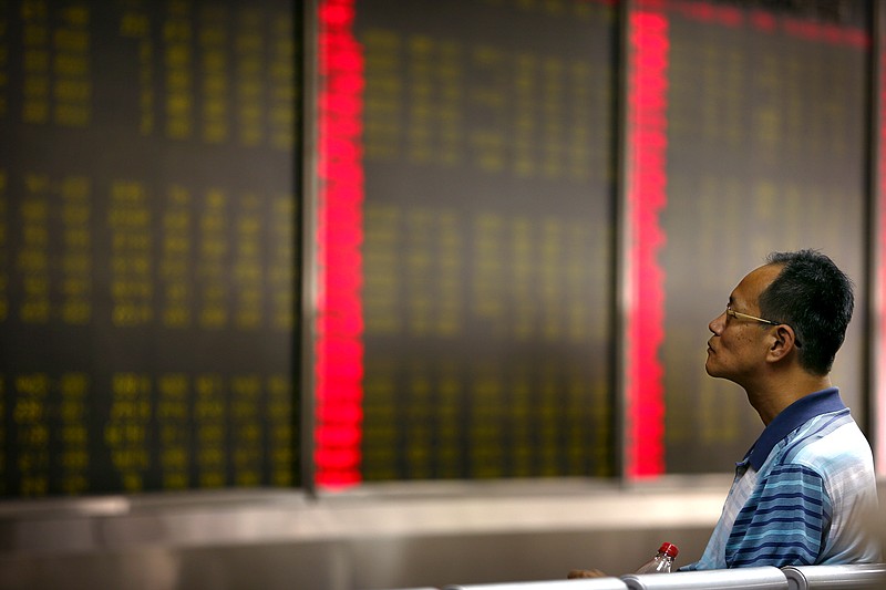 A Chinese investor monitors stock prices at a brokerage house in Beijing on Monday, Aug. 24, 2015. Stocks tumbled across Asia on Monday as investors shaken by the sell-off last week on Wall Street unloaded shares in practically every sector.