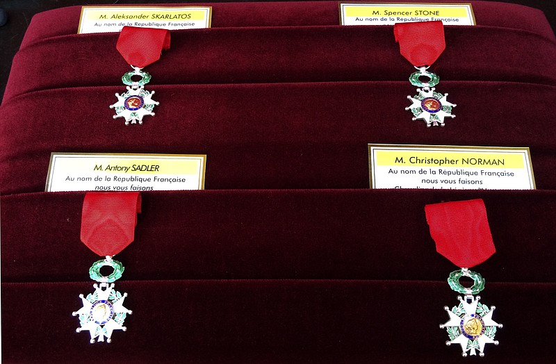 
              Legion of Honor medals for the three Americans and the British businessman, Chris Norman are pictured on a cushion at the Elysee Palace, Monday Aug.24, 2015 in Paris, France. French President Francois Hollande pinned the Legion of Honor medal on U.S. Airman Spencer Stone, National Guardsman Alek Skarlatos, and their years-long friend Anthony Sadler, who subdued the gunman as he moved through the train with an assault rifle strapped to his bare chest. The British businessman, Chris Norman, also jumped into the fray. (AP Photo/Catherine Gaschka , Pool)
            