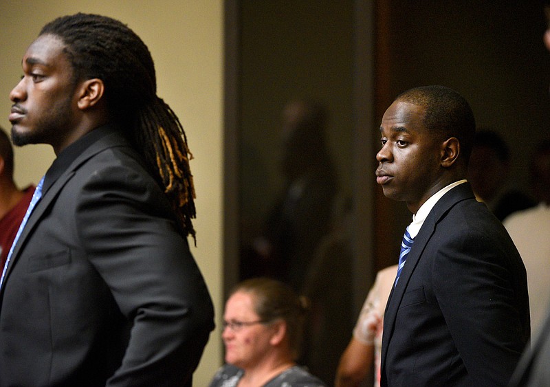 
              Former University of Tennessee football players Michael Williams, right, and A.J. Johnson stand in court before the start of Williams's rape trial Monday, Aug. 24, 2015, in Knoxville, Tenn. A judge granted the defense a delay to Sept. 29. The delay also postponed the trial of Johnson, a co-defendant being tried separately. (AP Photo/Knoxville News Sentinel, Michael Patrick)
            