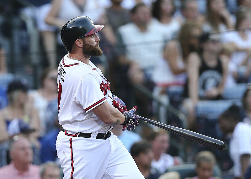 Atlanta Braves' Jonny Gomes follows through on a two-run home run in the first inning of a baseball game against the Colorado Rockies on Monday, Aug. 24, 2015, in Atlanta.