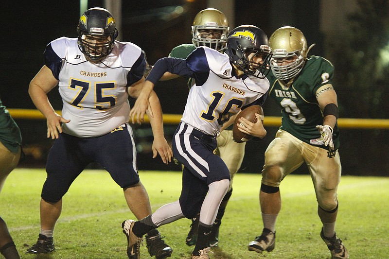 Staff Photo by Dan Henry / The Chattanooga Times Free Press- 11/7/14. Chattanooga Christian School's Matthew Mercer (16) runs the ball as Notre Dame defenders chase during the first half of the TSSAA Class 3A playoff game Friday, November 7, 2014 at the Fighting Irish‚Äôs home field. 