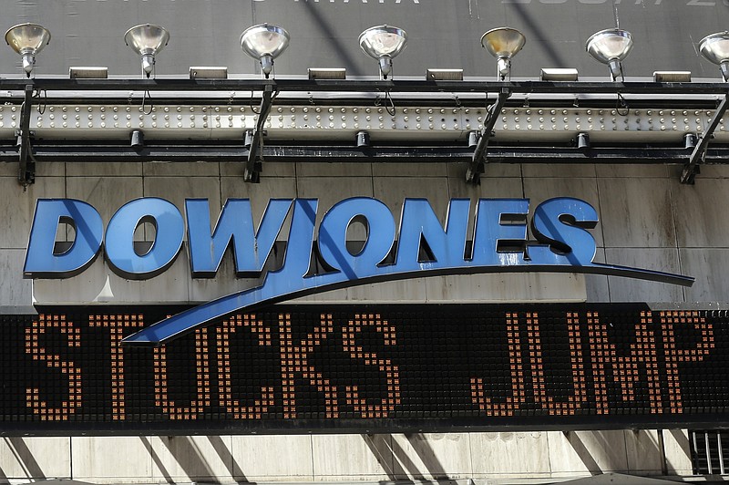 The Dow Jones ticker in Times square announces a stock rebound Tuesday in New York. U.S. stocks jumped at the open after China's central bank cut interest rates to support its economy. (AP Photo/Mary Altaffer)