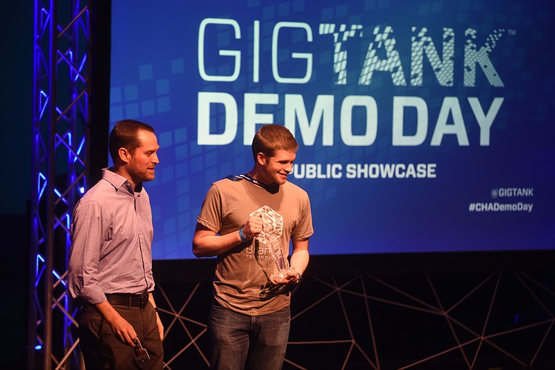Staff Photo by Angela Lewis Foster R. Platt Boyd, left, and Chris Weller, with Branch Technology, stand on the stage after receiving the Investor's Choice award at the Gigtank Demo Day Tuesday, July 28, 2015 at GPS.