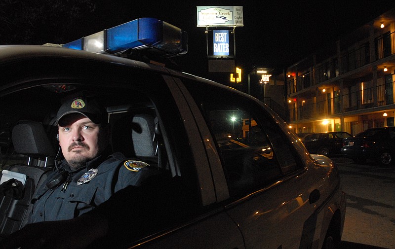 An officer from the East Ridge Police Department patrols the town one night.