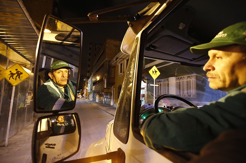 
              In this Aug. 19, 2015 photo, Jose Alberto Gutierrez drives a garbage truck in Bogota, Colombia. Gutierrez is an avid read of works by authors such as Leo Tolstoy, Victor Hugo and Mario Vargas Llosa. His favorite books include “One Hundred Years of Solitude” and “The General in his Labyrinth” by Colombia’s Nobel Prize-winning novelist Gabriel Garcia Marquez. (AP Photo/Fernando Vergara)
            