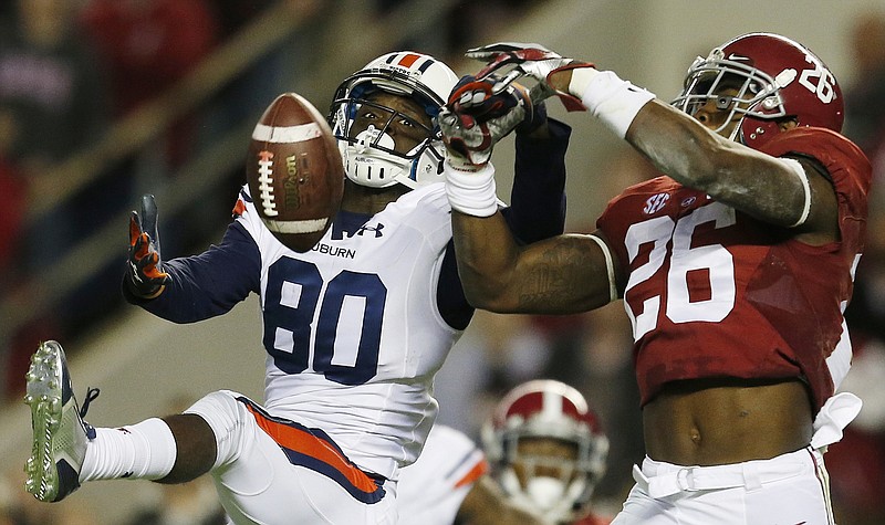 
              FILE - In this Nov. 29, 2014, file photo, Alabama defensive back Landon Collins (26) breaks up a pass meant for Auburn wide receiver Marcus Davis (80) during the first half of the Iron Bowl NCAA college football game in Tuscaloosa, Ala. Go into the bowl season with a chance to win the national championship. That's mostly been the case in recent years and no reason to think it won't happen again for these two teams. College football's most intense in-state rivalry has been wild the past two seasons with the Kick-6 going Auburn's way in 2013 and then a record-setting shootout being won by Alabama in 2015. The teams will meet Nov. 28, 2015 at Auburn. (AP Photo/Butch Dill, File)
            