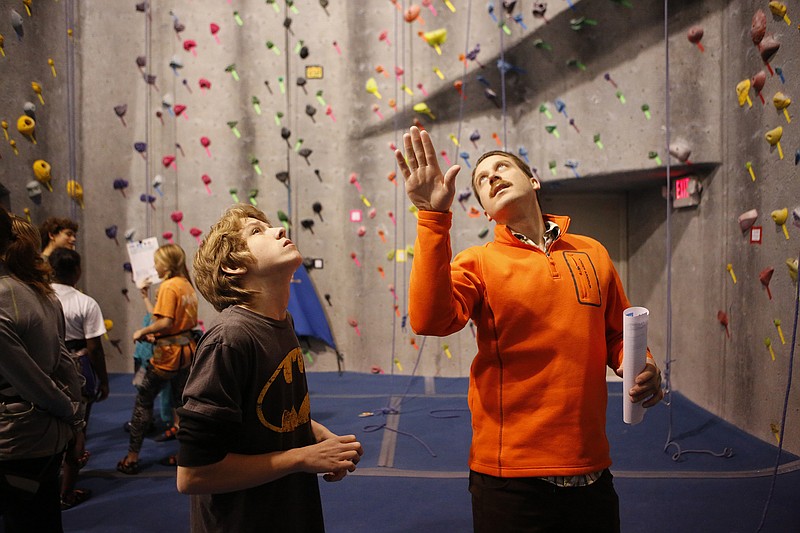 Zack Brown, a 10th-grader at Brainerd High School, left, talks with his climbing coach John Cunningham last year about climbing routes during a Chattanooga Area Interscholastic Climbing League event. An introductory meeting for this year's program will be at 5:30 p.m. Monday at Outdoor Chattanooga in Coolidge Park.