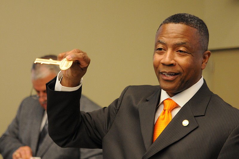 Tennessee Department of Corrections Commissioner Derrick Schofield shows attendees a commemorative key to the $208 million Bledsoe County Correctional Complex in 2012. The key was a gift to certain people in attendance following a ribbon cutting.