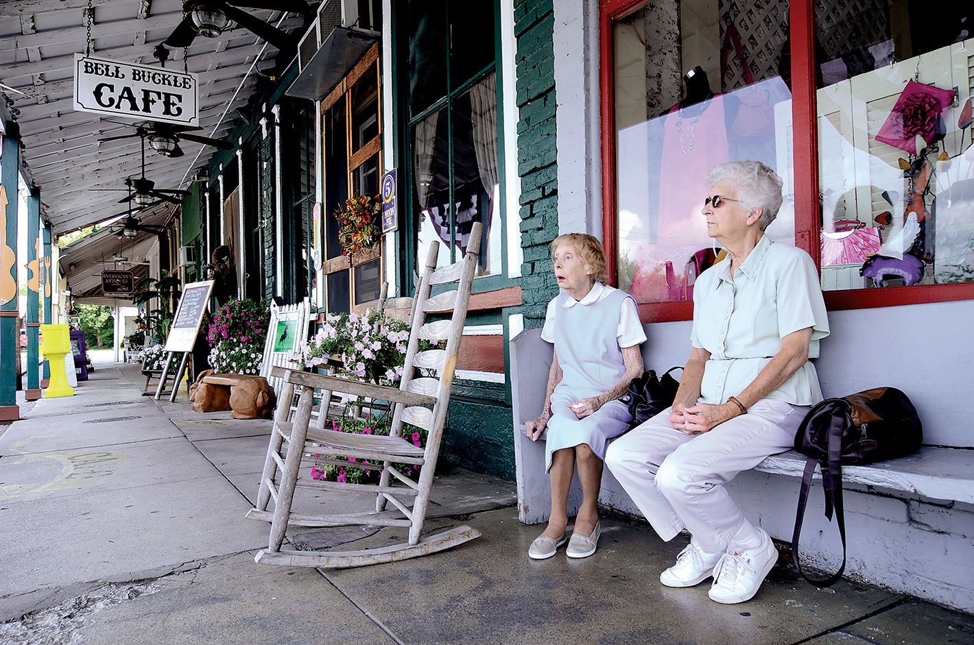 Jul 20, 2012-- Sisters Mary Williams, right, and Clara Conner sit on a bench outside of the shops in Bell Buckle, Tenn.