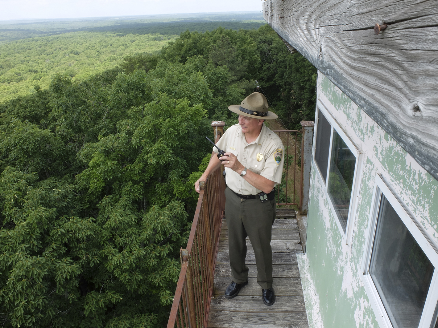 Stuart Carroll, 59, Fall Creek Falls State Park Resource Manager, stands atop the 80-foot fire tower on the eastern boundary of the park in Bledsoe County. The steel tower has recently been submitted to be on the National Register of Historic Places.