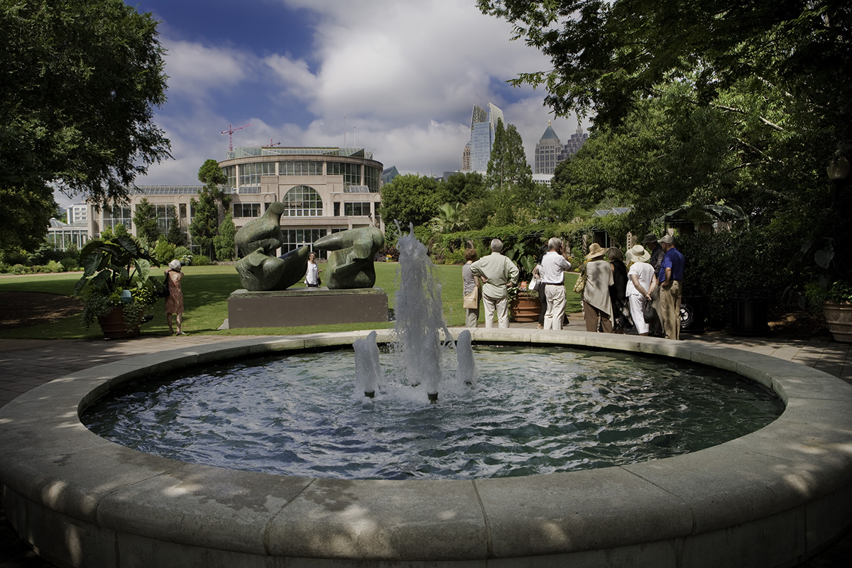 Visitors around the fountain in front of the Fuqua Conservatory at the Atlanta Botanical Garden.